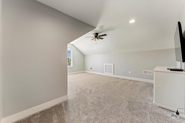 additional living space featuring baseboards, visible vents, ceiling fan, vaulted ceiling, and carpet floors