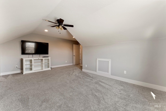 additional living space with lofted ceiling, carpet floors, a ceiling fan, and baseboards