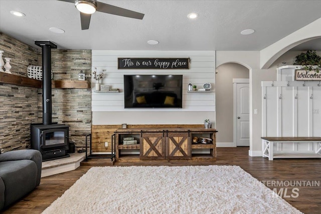 27985 Gray Sage Rd, Caldwell, ID 83607 - living area with a wood stove, a ceiling fan, wood finished floors, arched walkways, and recessed lighting