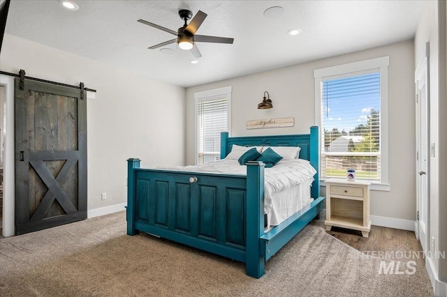 27985 Gray Sage Rd, Caldwell, ID 83607 - carpeted bedroom featuring a barn door, recessed lighting, baseboards, and a ceiling fan
