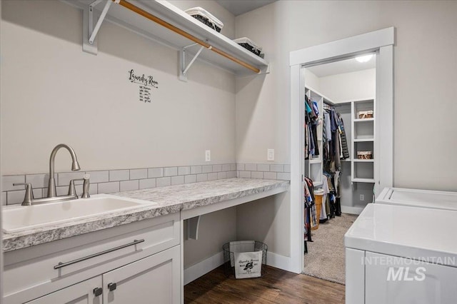 27985 Gray Sage Rd, Caldwell, ID 83607 - washroom featuring washing machine and clothes dryer, dark wood-type flooring, cabinet space, and baseboards