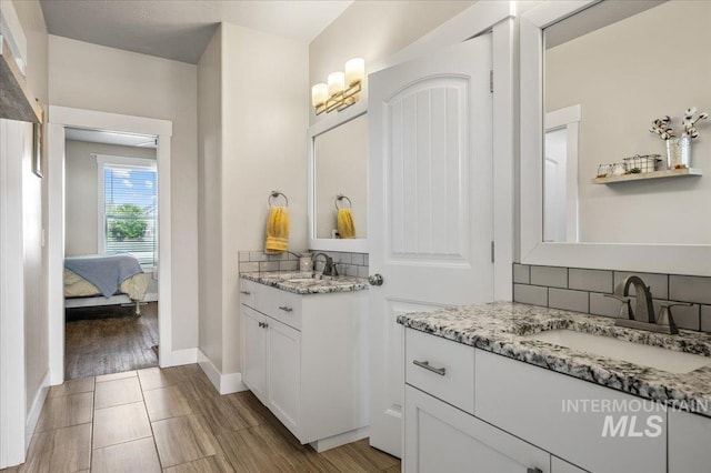 27985 Gray Sage Rd, Caldwell, ID 83607 - ensuite bathroom featuring backsplash, two vanities, and baseboards