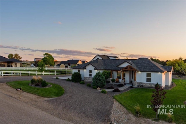 27985 Gray Sage Rd, Caldwell, ID 83607 - view of front facade featuring stone siding, a porch, and curved driveway