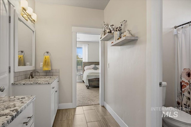 27985 Gray Sage Rd, Caldwell, ID 83607 - ensuite bathroom featuring vanity, toilet, baseboards, and a shower with curtain