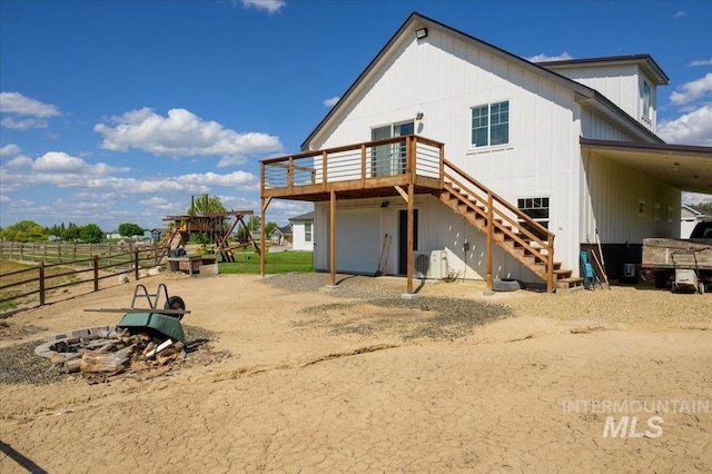 27985 Gray Sage Rd, Caldwell, ID 83607 - rear view of property featuring a wooden deck, stairs, a playground, and dirt driveway
