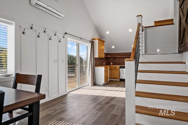 27985 Gray Sage Rd, Caldwell, ID 83607 - staircase with a wall mounted air conditioner, wood finished floors, recessed lighting, and vaulted ceiling