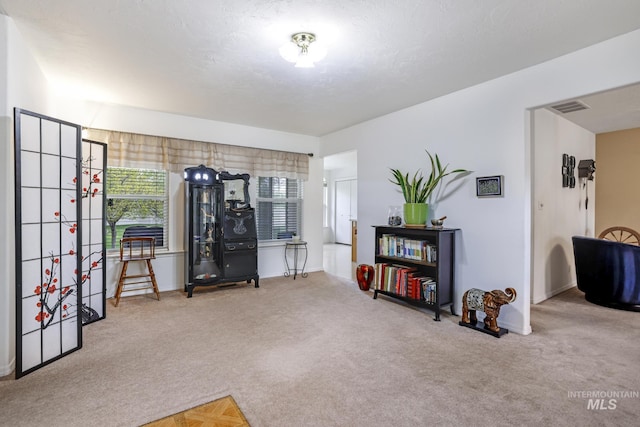 interior space with visible vents, carpet flooring, and baseboards
