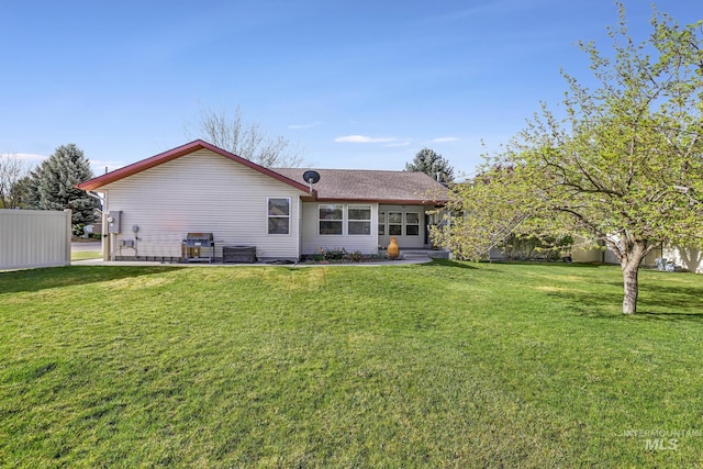 back of property featuring central AC unit and a yard