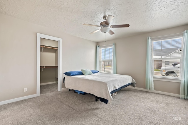 319 Magnolia Ave, Fruitland, ID 83619 - bedroom featuring carpet flooring, baseboards, a walk in closet, a textured ceiling, and a closet