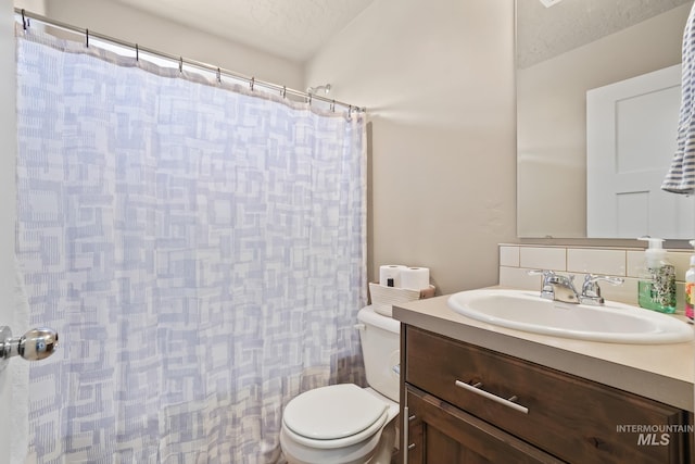 319 Magnolia Ave, Fruitland, ID 83619 - bathroom featuring toilet, vanity, a shower with shower curtain, and tasteful backsplash