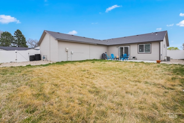319 Magnolia Ave, Fruitland, ID 83619 - back of property with a gate, a patio area, and central air condition unit