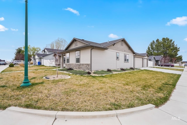 319 Magnolia Ave, Fruitland, ID 83619 - view of side of property featuring an attached garage, concrete driveway, and a lawn