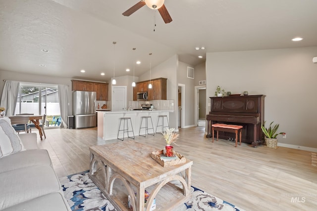 319 Magnolia Ave, Fruitland, ID 83619 - living room featuring recessed lighting, ceiling fan, baseboards, light wood-style floors, and high vaulted ceiling