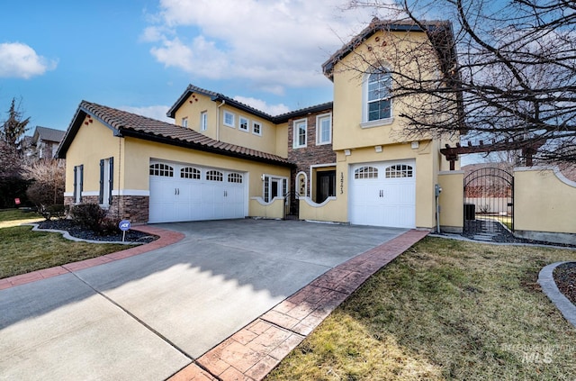 view of front of property featuring a gate, stone siding, driveway, and stucco siding