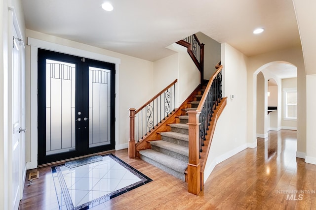 entryway featuring recessed lighting, stairs, baseboards, and wood finished floors