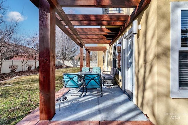 view of patio featuring outdoor dining space, fence, and a pergola