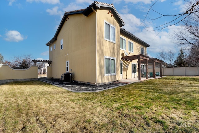 back of house with a yard, fence, and a pergola