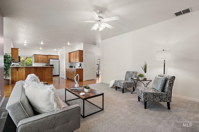 living room with ceiling fan and light carpet
