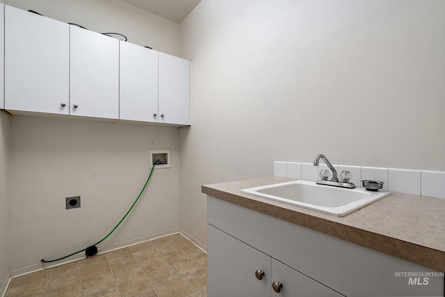 washroom with cabinet space, hookup for a washing machine, hookup for an electric dryer, and baseboards
