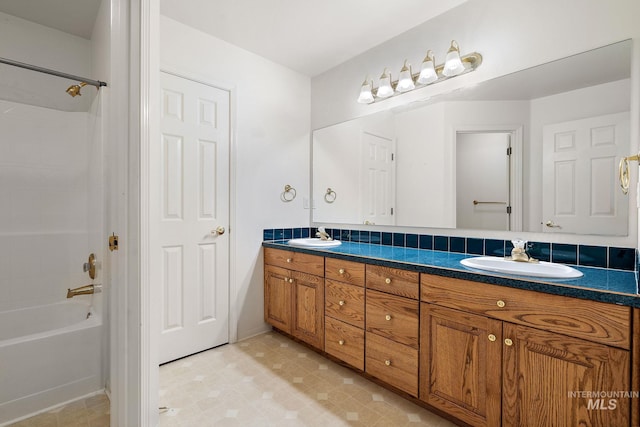 bathroom featuring double vanity and shower / bath combination
