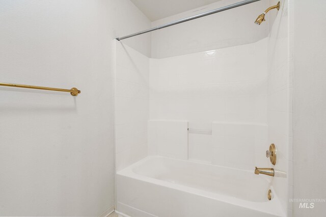 full bathroom featuring bathtub / shower combination and baseboards