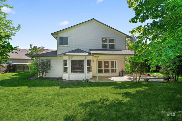 back of house with a patio area and a shingled roof
