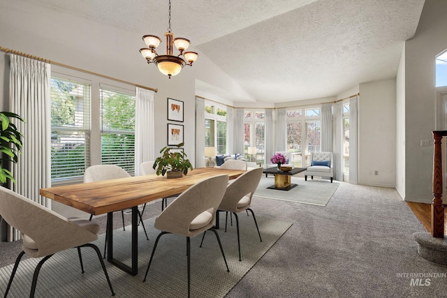 dining room with healthy amount of natural light, a textured ceiling, vaulted ceiling, a chandelier, and carpet flooring