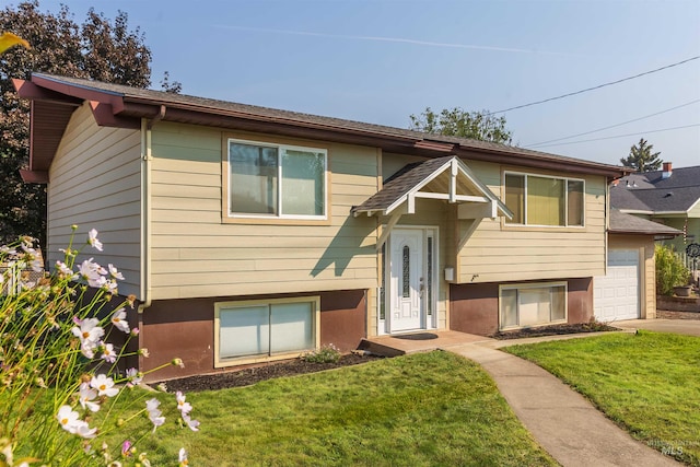 split foyer home with a garage and a front lawn