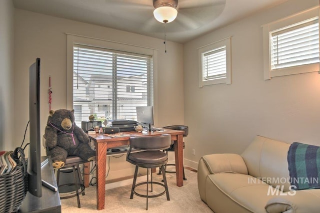 carpeted office space featuring baseboards