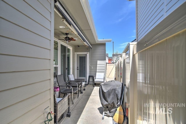 view of patio featuring area for grilling and fence