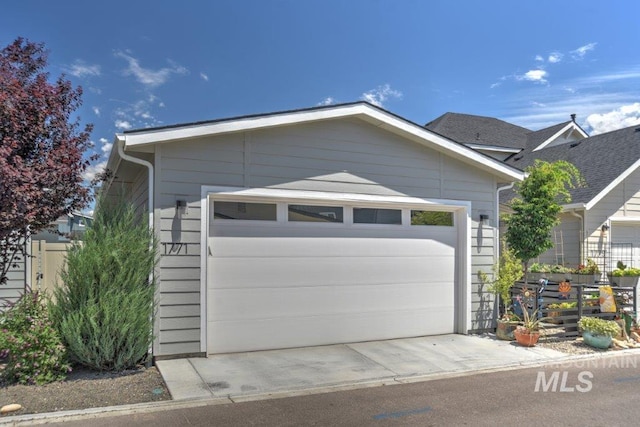 view of front facade with a garage and fence