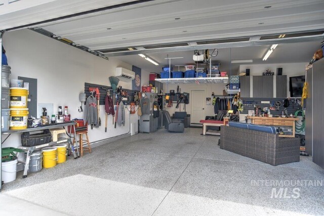 garage with a wall mounted AC and a workshop area