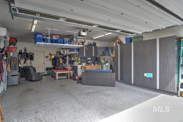 garage featuring a wall unit AC, a workshop area, and a garage door opener