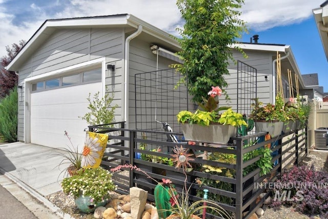 view of side of home with an outbuilding and fence