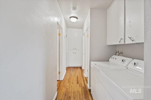 1325 E 5th N, Mountain Home, ID 83647 - laundry area with light wood-type flooring, cabinet space, and washer and dryer