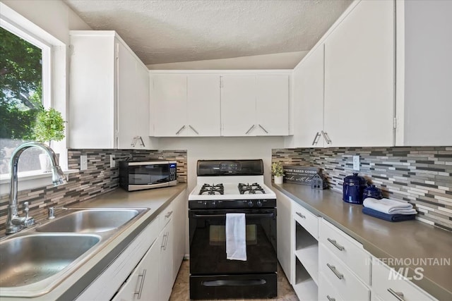 1325 E 5th N, Mountain Home, ID 83647 - kitchen with gas range oven, a sink, white cabinets, backsplash, and a textured ceiling