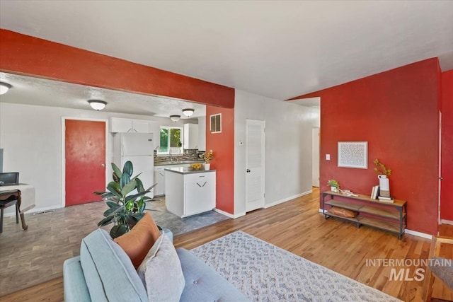 1325 E 5th N, Mountain Home, ID 83647 - living room with light wood-type flooring and baseboards