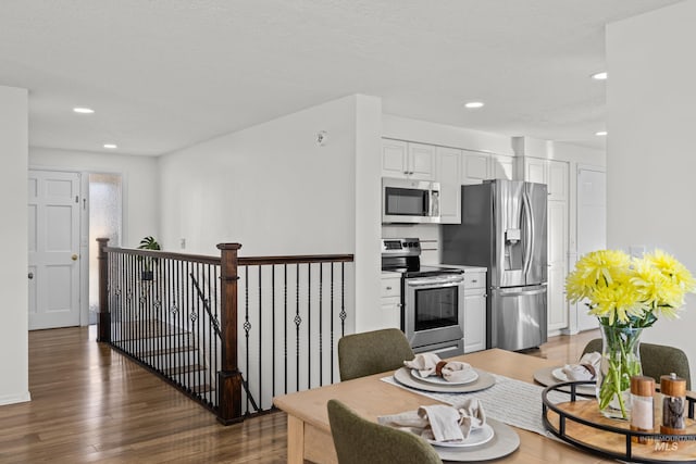 kitchen featuring light wood-style flooring, white cabinetry, stainless steel appliances, and recessed lighting