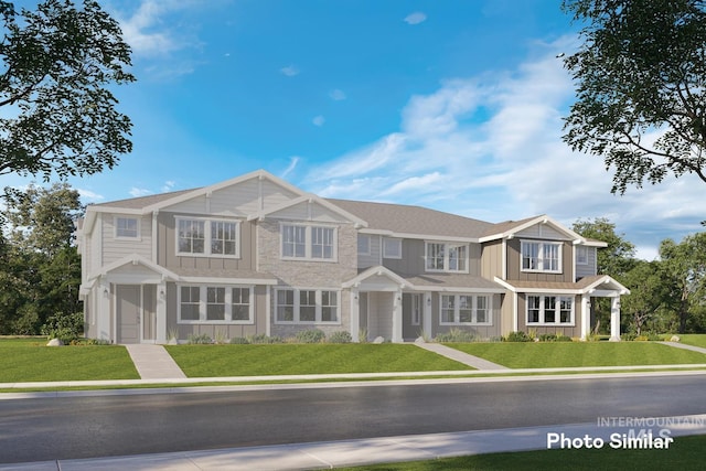 view of front of house with board and batten siding and a front yard