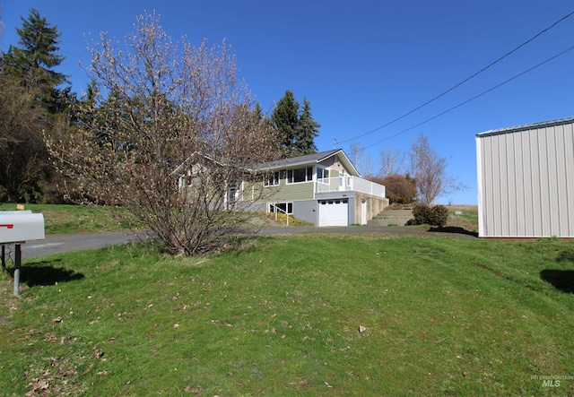 view of yard with a garage and driveway
