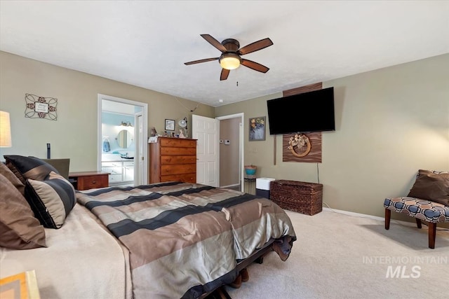 carpeted bedroom featuring ceiling fan and ensuite bath