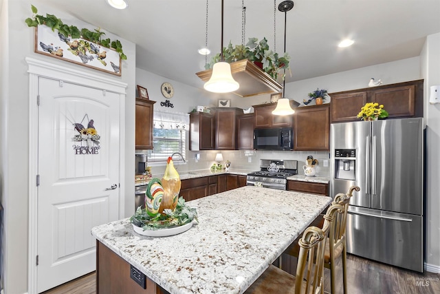 1011 Lynx, Jerome, ID 83338 - kitchen featuring stainless steel appliances, a kitchen island, dark brown cabinetry, dark wood-style floors, and light stone countertops