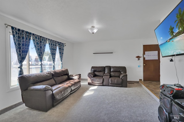 carpeted living area featuring baseboards