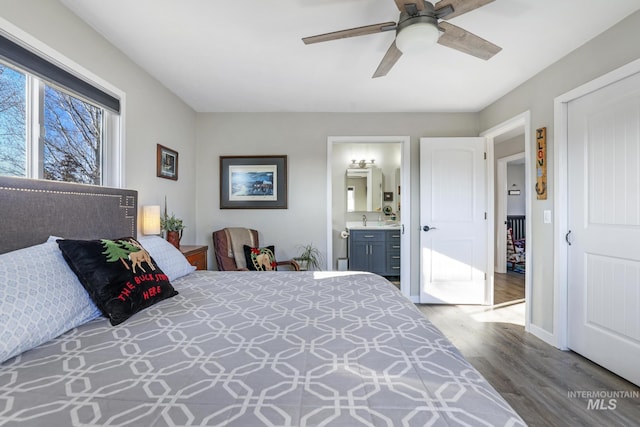 bedroom with connected bathroom, ceiling fan, and hardwood / wood-style floors