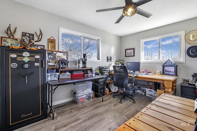 home office with wood-type flooring and ceiling fan