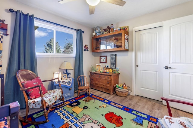 rec room featuring ceiling fan and light hardwood / wood-style floors