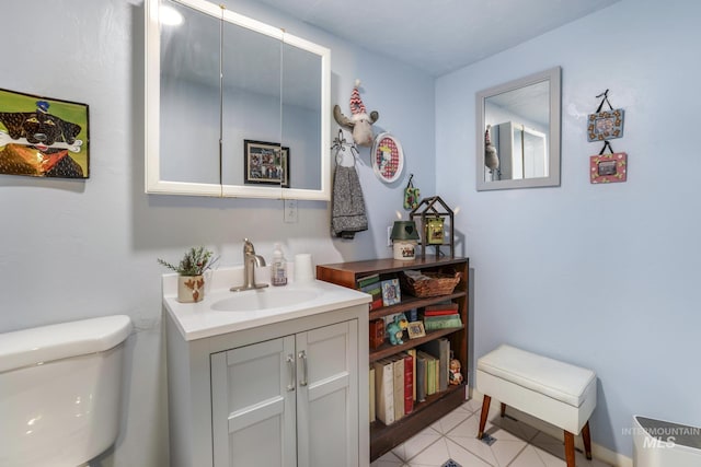 bathroom with tile patterned flooring, vanity, and toilet