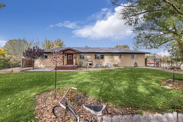 rear view of property with a lawn