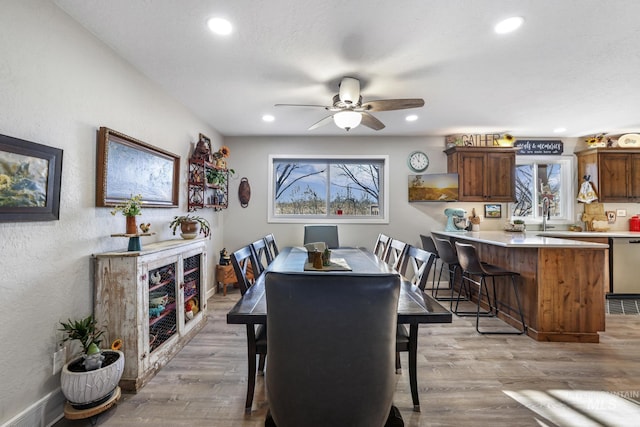 dining space featuring light hardwood / wood-style floors, a wealth of natural light, and ceiling fan