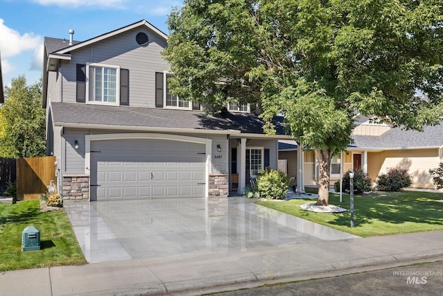 view of front facade with a garage and a front lawn